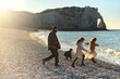 © Iuliia Versta/Stocksy - family have a fun on a rocky beach of Etretat