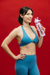 © wedmoments.stock - Fitness and hydration concept with athletic woman and water bottle on isolated background.