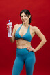 © wedmoments.stock - Sporty female model holding water bottle. Hydration, workout and wellness concept.
