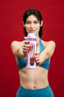 © wedmoments.stock - Woman in sportswear holding water bottle on isolated background. Active lifestyle concept.