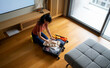 © Artcore Studio/Stocksy - Woman packing suitcase for journey, preparing for travel