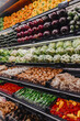 © Heng Yu/Stocksy - Colorful organic vegetables displayed on grocery shelf