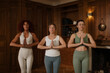 © DZ FILM/Stocksy - Three women practice yoga together