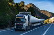 © M. Perfectti - Special transport truck carrying an oversized wind turbine blade on a rural road