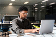 © Santi Nuñez/Stocksy - Black man working in office using laptop