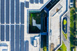 © Yic Ma/Stocksy - Solar panels on office building rooftop