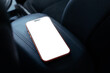© Marcos Osorio/Stocksy - Smartphone placed on a seat in indoor setting