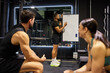 © Javier Díez/Stocksy - Trainer gives workout plan to a small group in gym setting