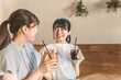 © buritora - Young Asian woman drinking a drink enjoying a girls' night out at a cafe