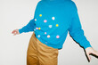 © Colour Laboratory/Stocksy - Person wearing shirt with colourful furry dots with direct flashlight