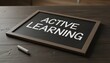 © Mary Patricia - Chalkboard displays the words ACTIVE LEARNING written in white chalk on a dark surface with a piece of chalk resting beside it education teaching school knowledge concept writing