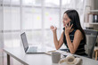 © Wasana - Businesswoman engaged in phone call at desk
