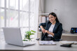© Wasana - Professional woman smiling in modern office setting