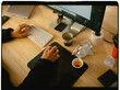 © Adrian Rodd/Stocksy - Anonymous person working on a computer at a messy desk