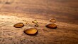 © laptop - Water droplets sit atop a wooden surface with varied warm brown hues and a soft, blurred background