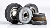 Close-up of grinding, cutting, and flap wheels showing grit textures on white backdrop