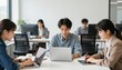 © Nawaphon - Young adults working on laptops and tablet in modern office space