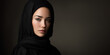 © AnaKonda.ai - Young Muslim woman wearing hijab with neutral expression on dark background