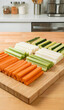 © 현욱 김 - Freshly cut colorful vegetable sticks arranged on a wooden cutting board in a modern kitchen setting.