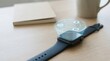 © Nasrin - Smartwatch with holographic UI icons on wooden desk, notebook and coffee cup in background, wearable technology concept