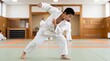 © Tatyana - Japanese boy practicing judo throw in dojo with focused expression