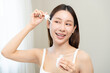 © KMPZZZ - Happy beauty routine, asian young woman, girl with makeup looking in mirror, hand dropping collagen moisturizer from pipette, applying vitamin using oil serum on face moisturizing for hydrating skin.
