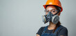 © Vadym - Woman wears protective respirator and orange hard hat. Safety goggles shield eyes from dust and chemical fumes. Worker ready for industrial job, construction site.