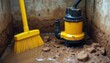 © Pete - Yellow sump pump sits in dirty water near broom. Basement flooding cleanup involves clearing mud debris and pipe maintenance. Emergency water removal for home.