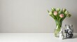 © TUL - Fresh tulips in a vase with a ceramic elephant figurine on a white surface
