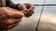 © AudaX - A fisherman's hands attaching a feathered lure to a line.