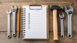 © Anat art - Checklist for Toilet Repair With Tools and Notebook on Wooden Table Ready for Use