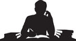 © shopone - Silhouette of person reading books at a desk