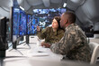 © Andrey Popov - Soldiers In Military Control Center Monitor Maps On Multiple Screens