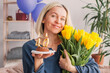 © Tatyana Gladskih - Portrait of happy middle aged woman holding birthday cake with lit candles
