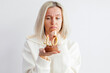 © Tatyana Gladskih - Adult unhappy beautiful woman forty years with festive cupcake with candle