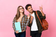 © luismolinero - Young student couple isolated on white background pointing with the index finger a great idea