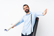 © luismolinero - Young architect man with beard over isolated white background presenting and inviting to come with hand