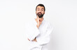 © luismolinero - Young man doing karate over isolated white background Looking front