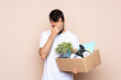 © luismolinero - Man holding a box and moving in new home over isolated background with tired and sick expression
