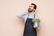 © luismolinero - Man holding a plant over isolated background thinking an idea