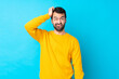 © luismolinero - Young caucasian man over isolated blue background with an expression of frustration and not understanding