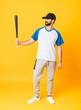 © luismolinero - Full-length shot of man over isolated yellow background playing baseball