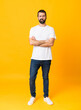 © luismolinero - Full-length shot of man with beard over isolated yellow background feeling upset