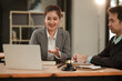 © aekachai - lawyers or attorneys discussing a contract agreement. Successful businessmen have a contract in place to protect it,signing of modest agreements form in office...