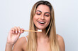 © luismolinero - Young caucasian woman isolated on white background with a toothbrush