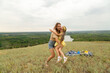 © Mariia - Mother with daughter having fun in field on summer day