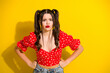 © deagreez - Young glamorous girl in red floral top posing with hands on hips against yellow background