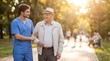 © Artem Zatsepilin - young caucasian male nurse supporting senior man walking in sunny park. caregiver and patient talking outdoors. elderly care, retirement assistance concept. healthcare banner, website header.