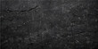© QUALITY BOOST - A dark and rough old black asphalt texture shows a weathered grey stone pattern on a grunge street road surface material with a detailed granite and concrete design wallpaper closeup