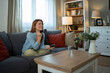 © Jelena - Happy woman celebrating victory playing video game at home